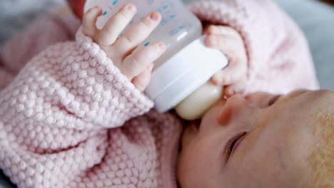 Sweet-baby-girl-drinking-milk-from-bottle